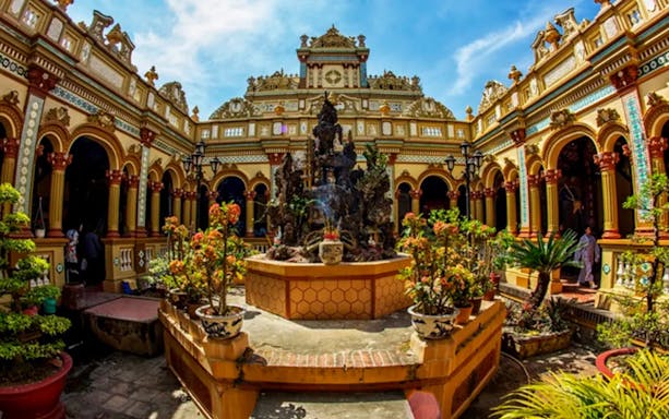 Vinh Trang Pagoda courtyard with ornate architecture, Mekong Delta tour.