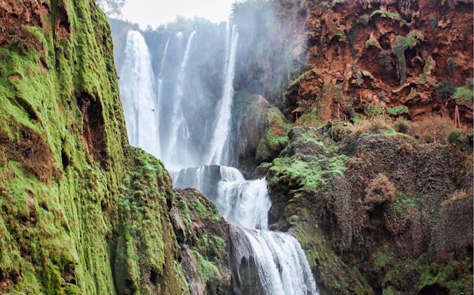 Ouzoud Waterfalls cascading over lush cliffs in Marrakesh, Morocco.