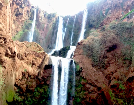 Ouzoud Waterfalls cascading over red cliffs, seen on a day tour from Marrakesh.