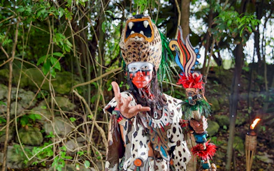 Performer in traditional costume at Xcaret Park, Mexico.
