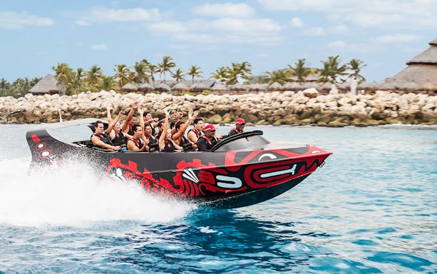 Visitors enjoying a speedboat ride at Xcaret Park, Mexico.