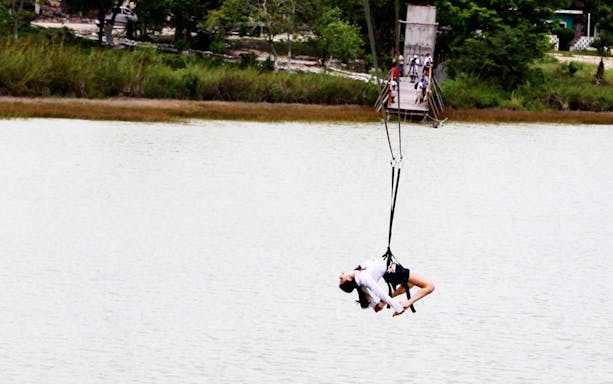 Ziplining over a lake during the Coba Xtreme tour in Mexico.