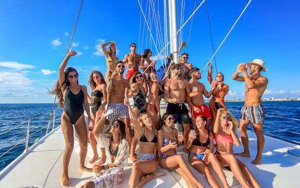 Group enjoying sailing on a catamaran near Isla Mujeres.