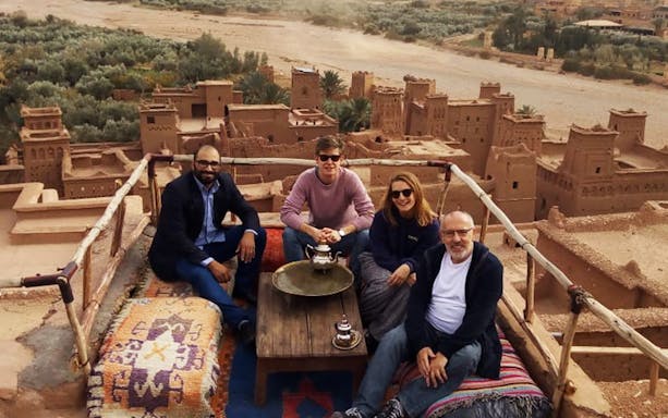 Group enjoying tea with view of Kasbah Aït Benhaddou, Ouarzazate.