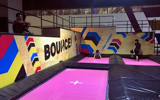 Indoor trampoline area at BOUNCE Thailand, The EmQuartier, with colorful wall designs.