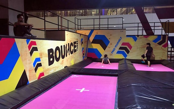 Indoor trampoline area at BOUNCE Thailand, The EmQuartier, with colorful wall designs.