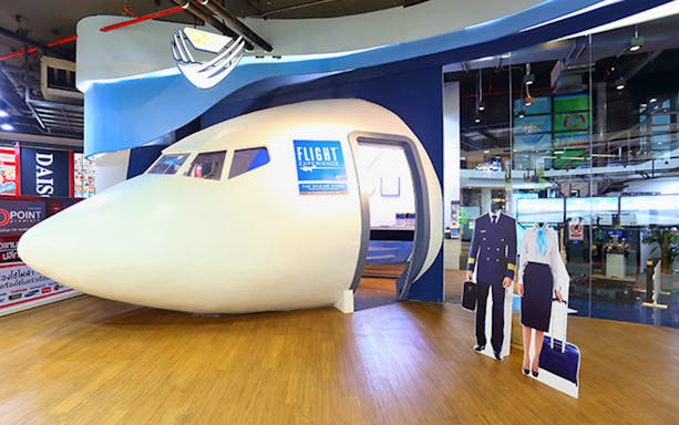 Flight simulation entrance at Flight Experience™ with pilot and crew cutouts.