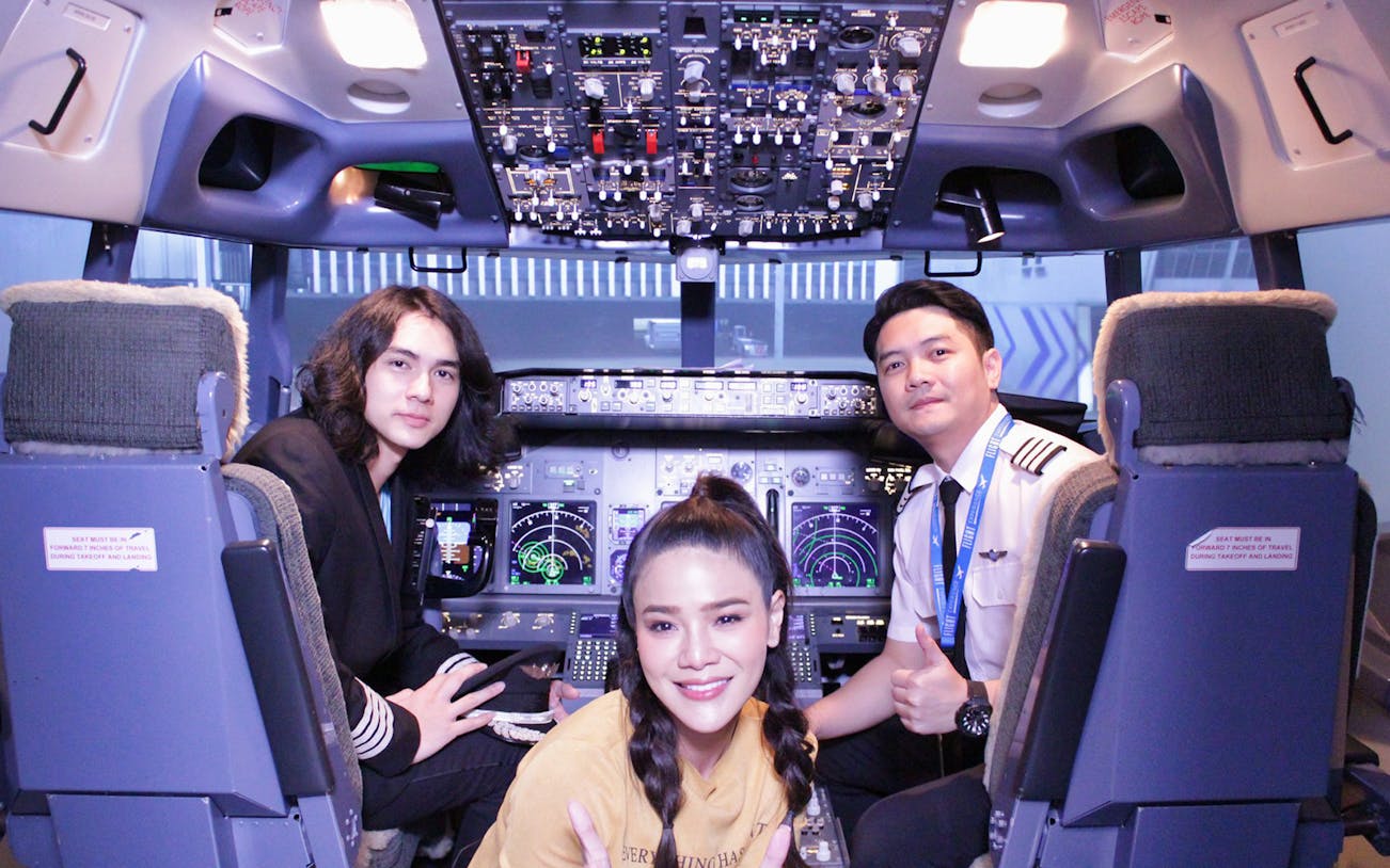 Flight simulator cockpit with participants and instructor at Flight Experience™.