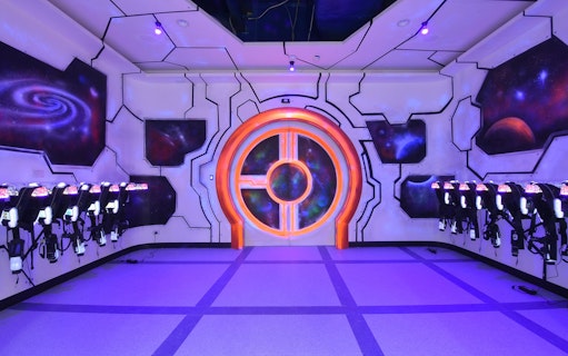 Laser tag arena with neon lights and space-themed decor at Playsquare Laser Tag, Central World.