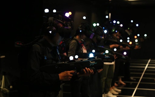 Participants in VR gear at Zero Latency Bangkok experience game.