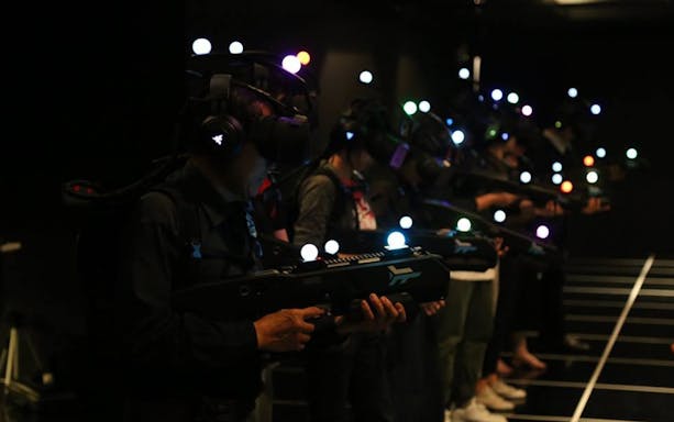 Participants in VR gear at Zero Latency Bangkok experience game.
