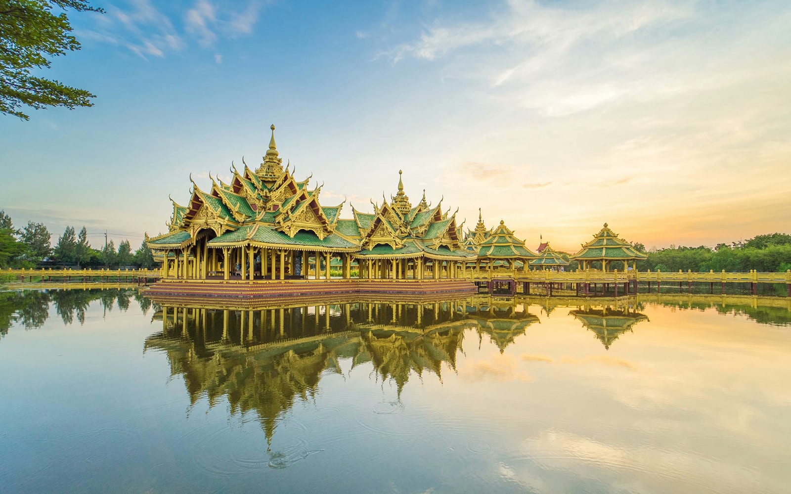 Tourists exploring the Ancient City and Erawan Museum in Bangkok, admiring the intricate architecture and lush surroundings