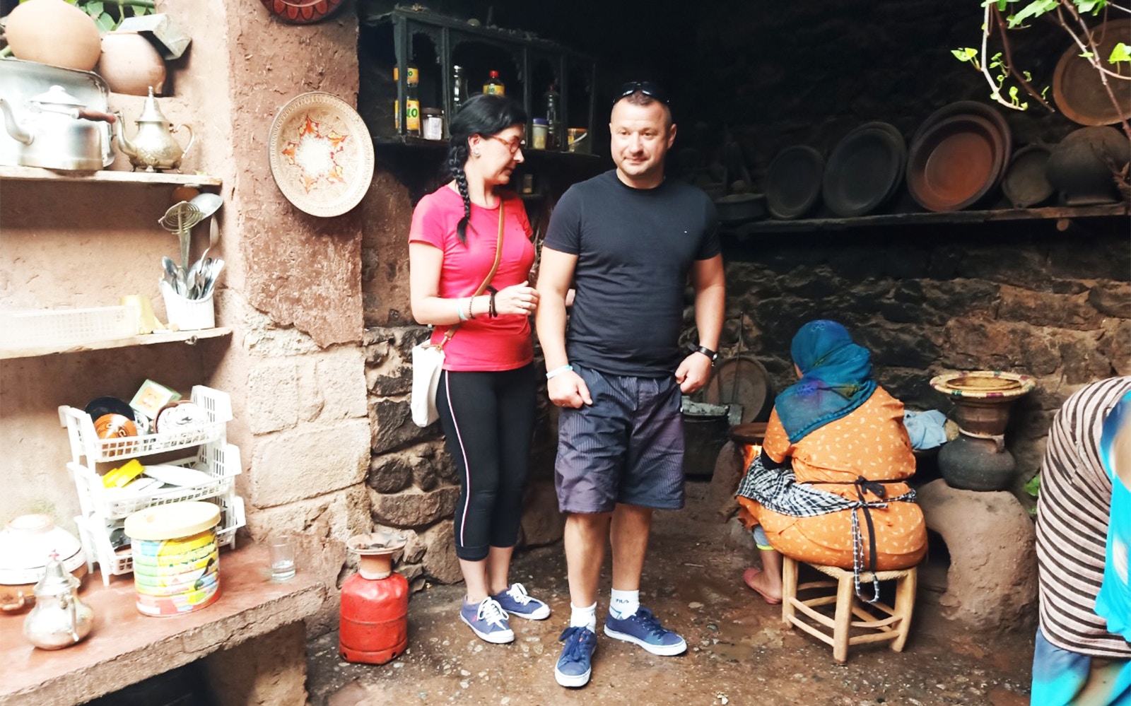 Visitors in a traditional kitchen during the Ourika Valley tour from Marrakesh.
