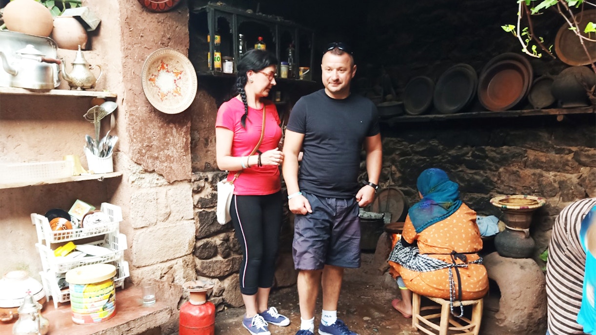 Visitors in a traditional kitchen during the Ourika Valley tour from Marrakesh.