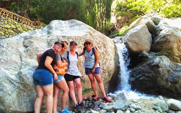 Group of hikers by a waterfall in Ourika Valley, near Marrakesh, High Atlas Mountains.