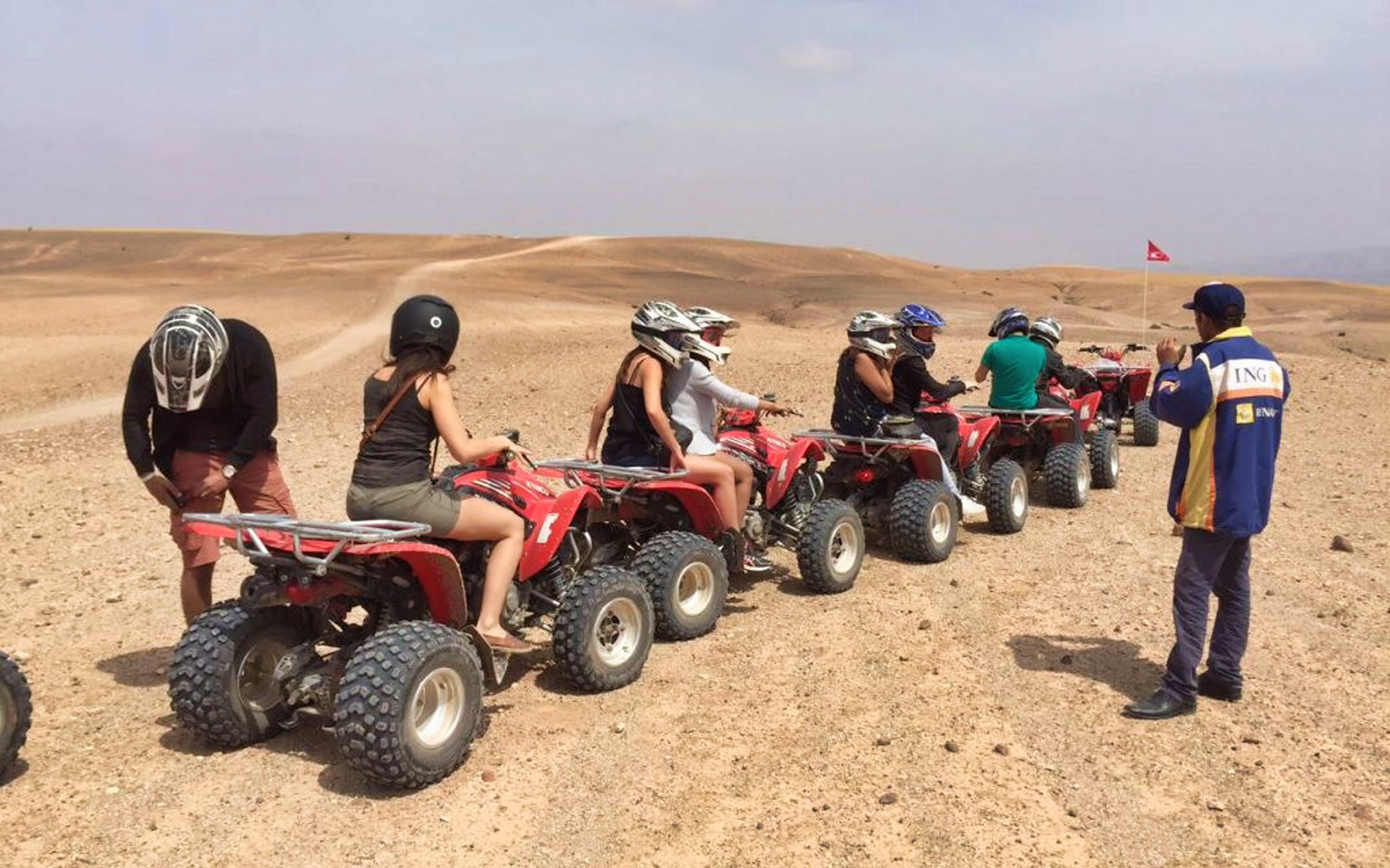 Group riding quad bikes in Agafay Desert near Marrakech.