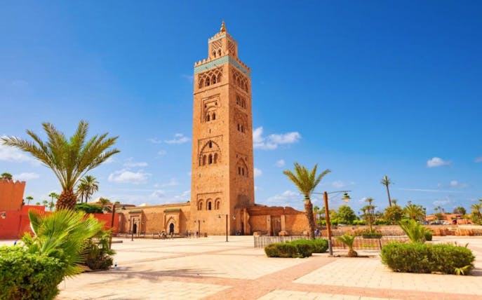 Koutoubia Mosque tower in Marrakesh under a clear blue sky.