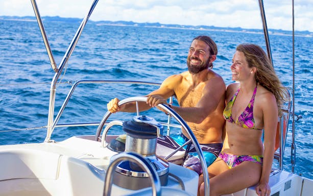 Couple enjoying sailing on a yacht in Cabo San Lucas.
