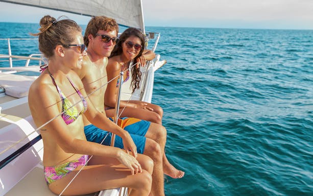 Group enjoying a sailing tour on a yacht in Cabo San Lucas.