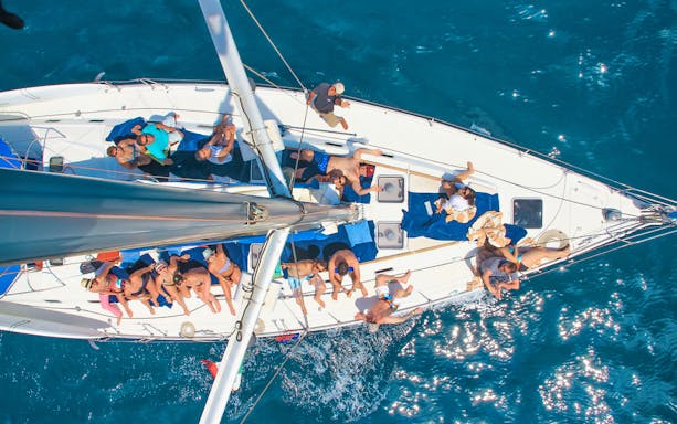 Aerial view of people relaxing on a sailboat during a Cabo San Lucas luxury day sailing tour.