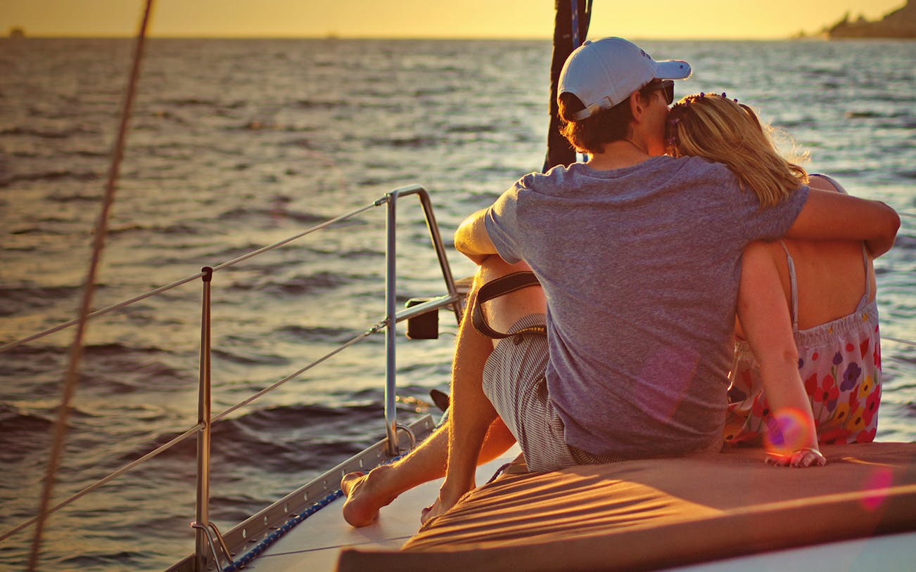 Couple enjoying sunset on a Cabo San Lucas dinner cruise.