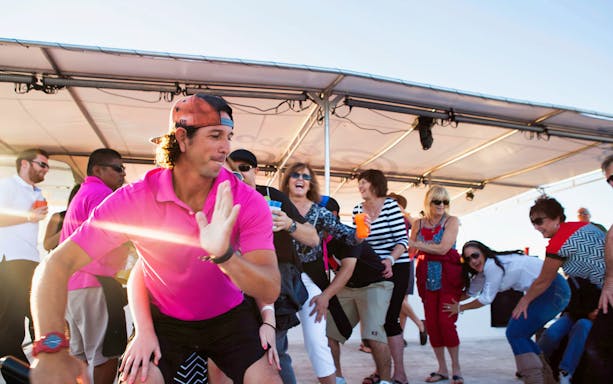 Guests dancing on a Cabo San Lucas sunset dinner cruise.