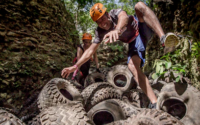 Visitors navigating tire obstacle course at Xplor Park.