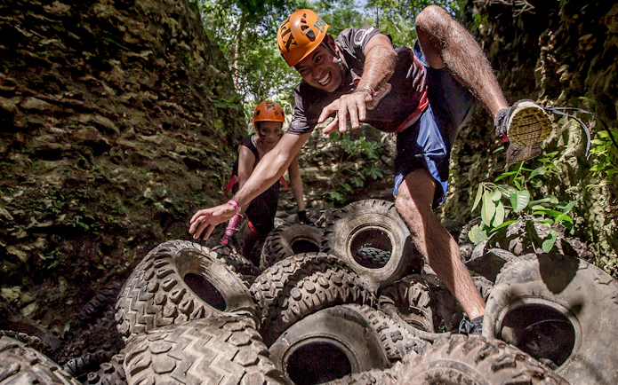 Visitors navigating tire obstacle course at Xplor Park.