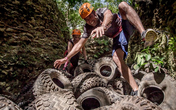 Visitors navigating tire obstacle course at Xplor Park.