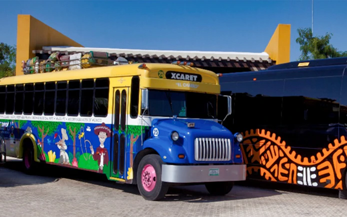 Colorful Xcaret bus for Xplor Park 1-day tour with official transportation.