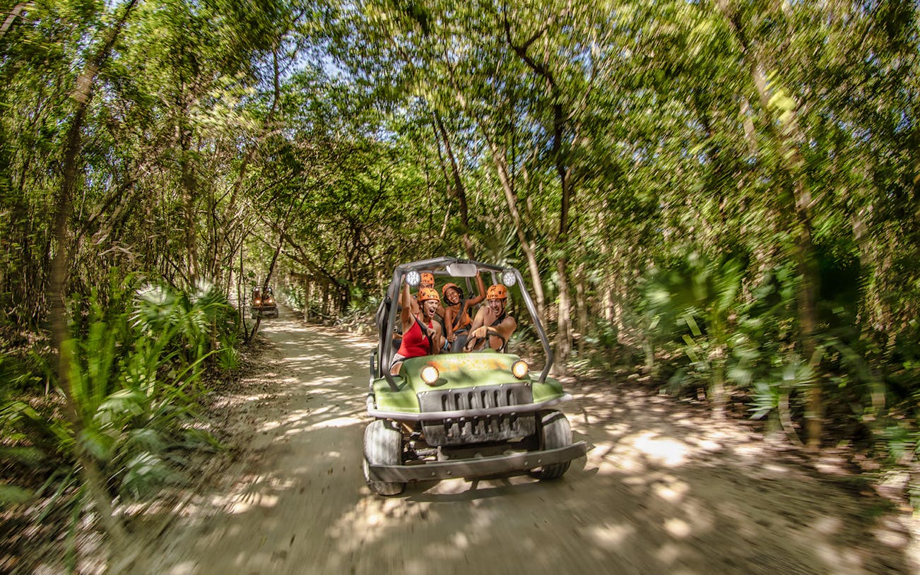 ATV ride through jungle at Xplor Fuego Park, Mexico.