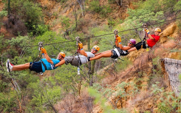 Group ziplining over a canyon in Los Cabos on the Monster Ziplines & Canyon Bridge Tour.