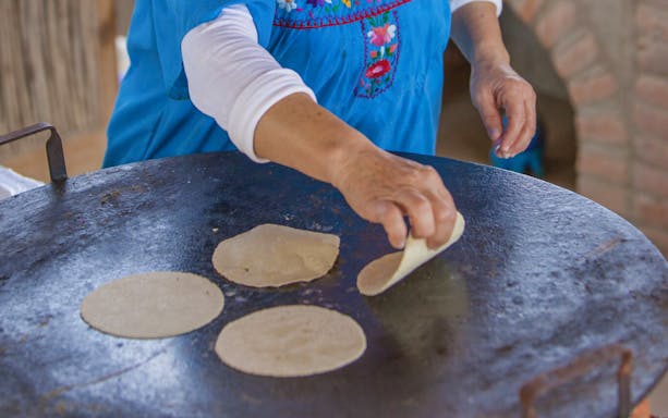 Making tortillas on a griddle during Cabo San Lucas Baja Desert Camel Safari.