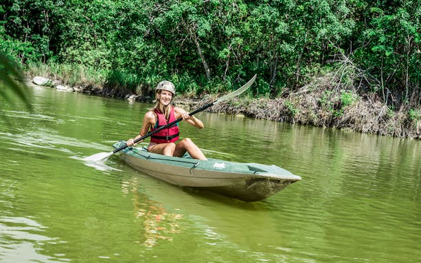 Kayaking adventure at Xavage Park with lush greenery in the background.