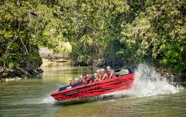 Jet boat ride through lush jungle at Xavage Park, Mexico.