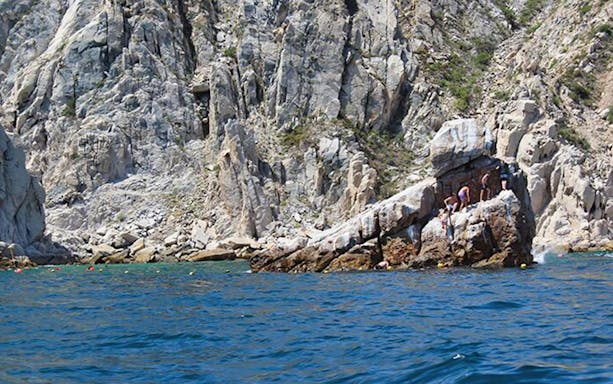 Snorkelers exploring vibrant marine life in Cabo San Lucas's Aquarium of the World.