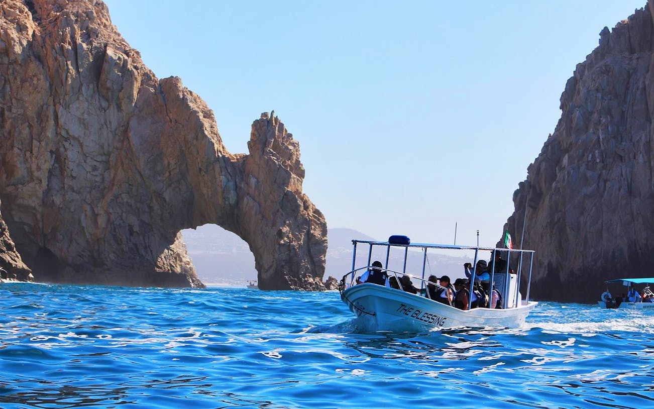 Boat near El Arco rock formation in Cabo San Lucas, Mexico.