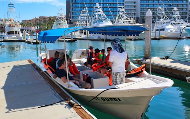 Tourists on a boat at Los Cabos marina during city tour with lunch and tequila tasting.