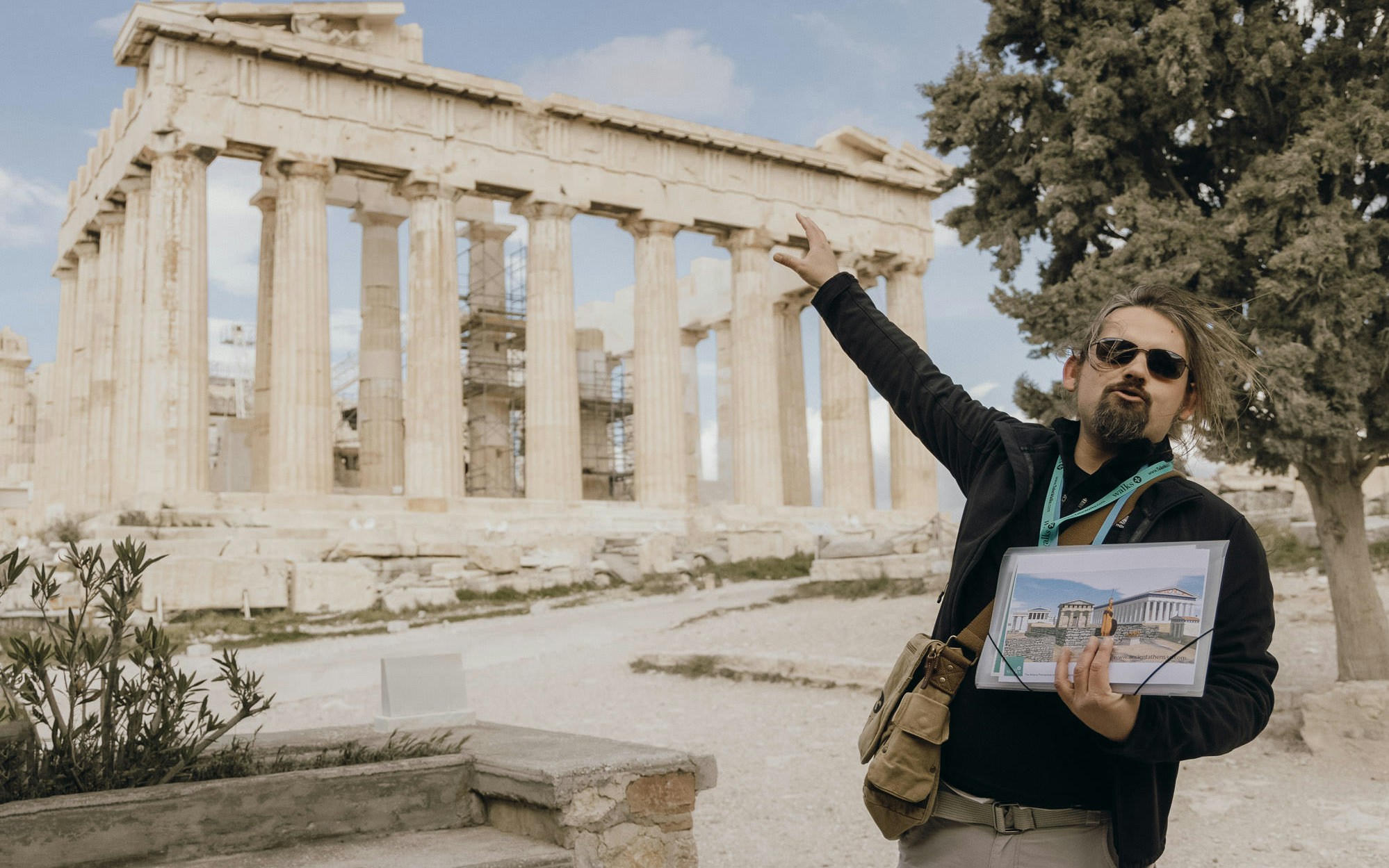 Tour guide at the Acropolis of Athens explaining the Parthenon.