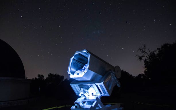 Telescope under starry sky at Mallorca Planetarium Observatory.