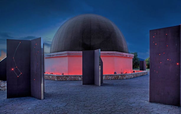 Mallorca Planetarium dome with illuminated constellation displays at night.