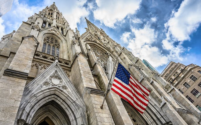 St. Patrick's Cathedral facade with American flag, New York City.