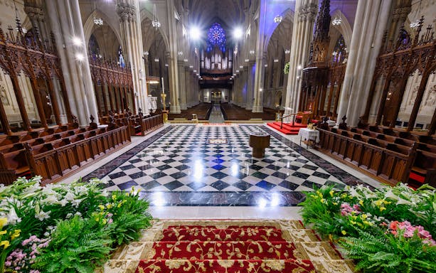 St. Patrick's Cathedral interior with ornate altar and stained glass window, New York City.