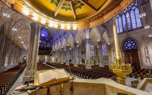 St. Patrick's Cathedral interior with stained glass windows and ornate pulpit.