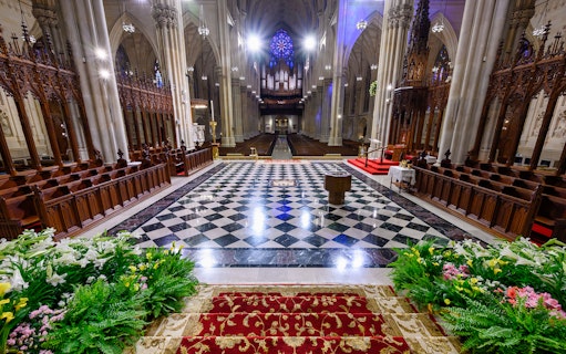 Interior of St. Patrick's Cathedral with ornate columns and stained glass, New York City.