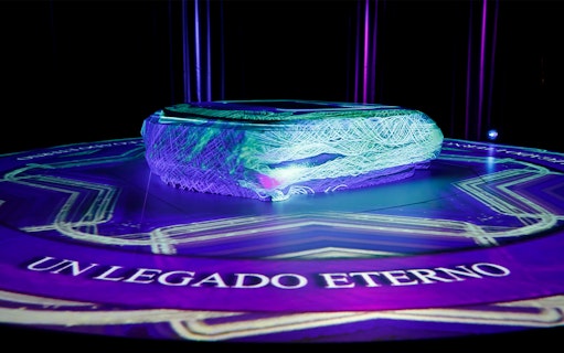 Interactive exhibit at Santiago Bernabéu Stadium Museum with glowing lights and "Un Legado Eterno" text.