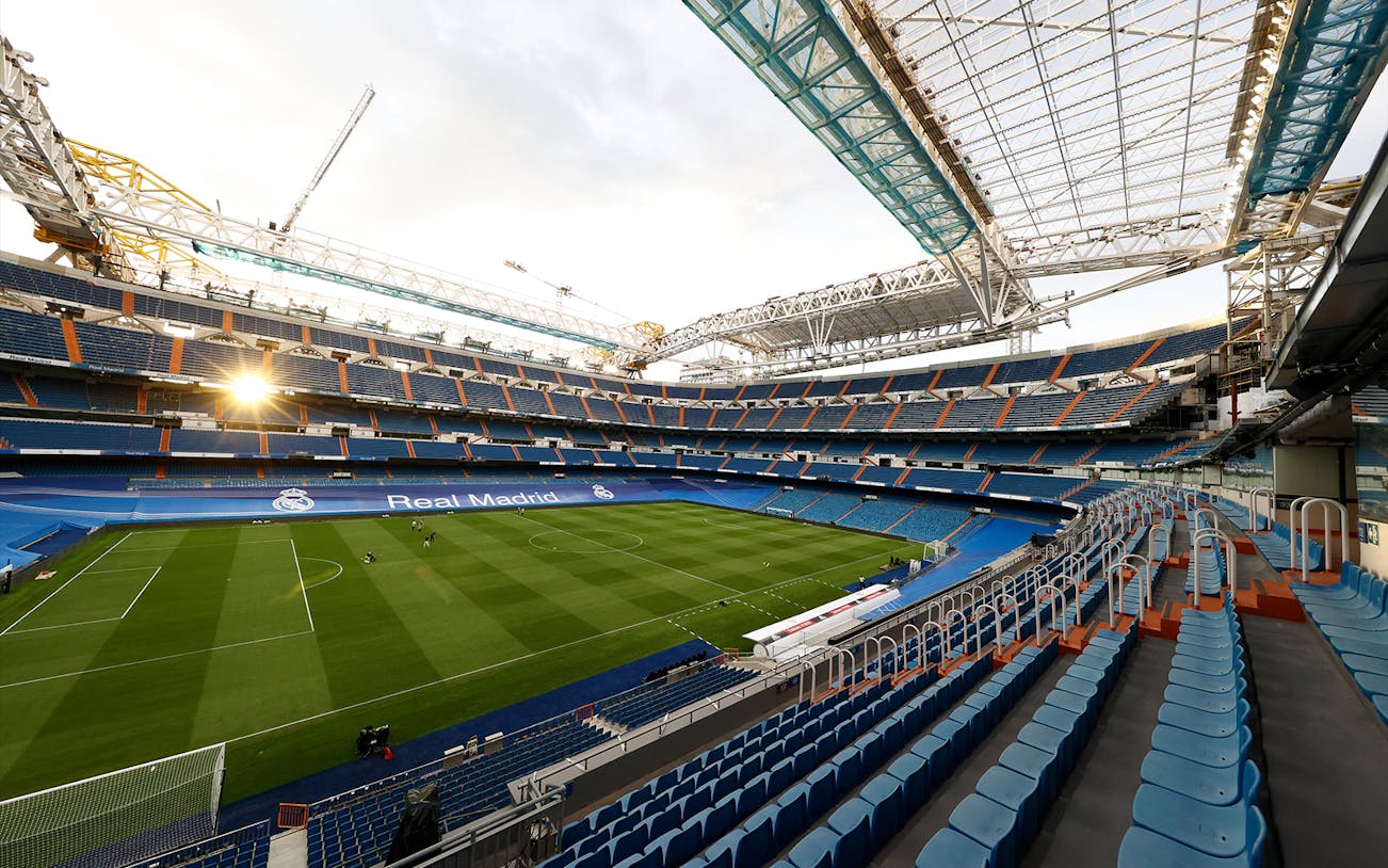 Santiago Bernabéu Stadium interior with empty seats and view of the pitch in Madrid, Spain.