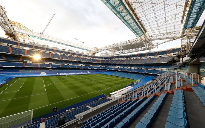 Santiago Bernabéu Stadium interior with empty seats and view of the pitch in Madrid, Spain.