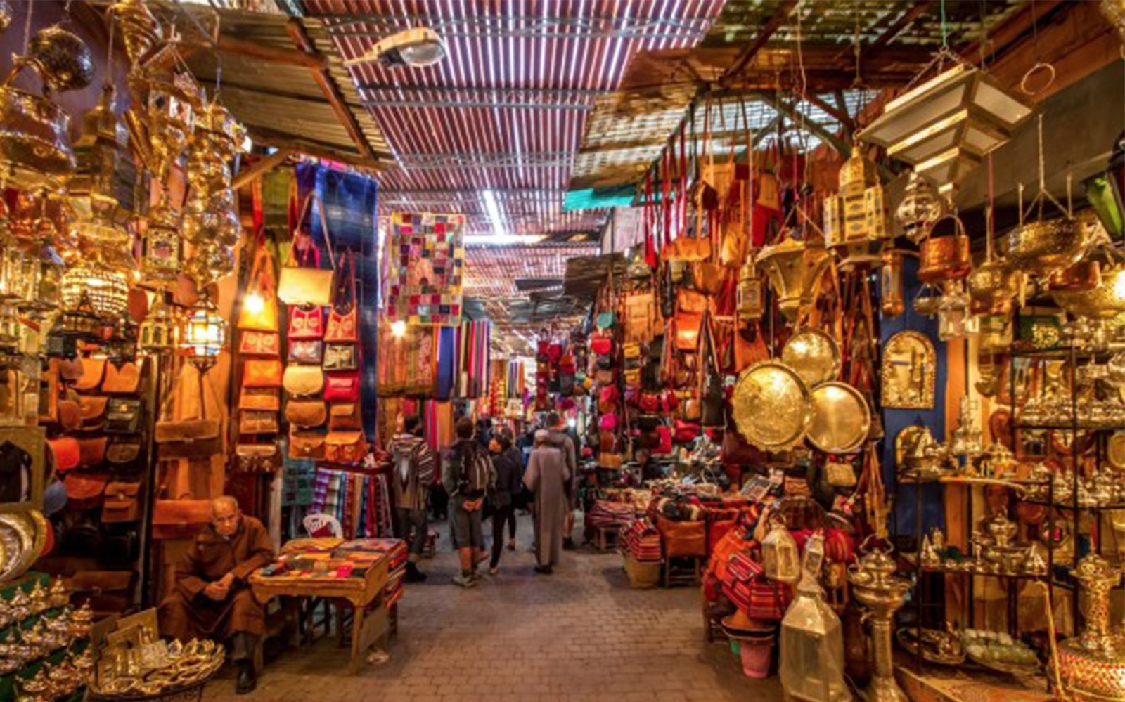 Marrakesh market with colorful textiles and traditional lamps on a private tour.