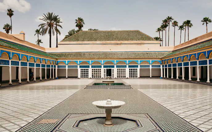 Bahia Palace courtyard with fountain and arched colonnades in Marrakesh.